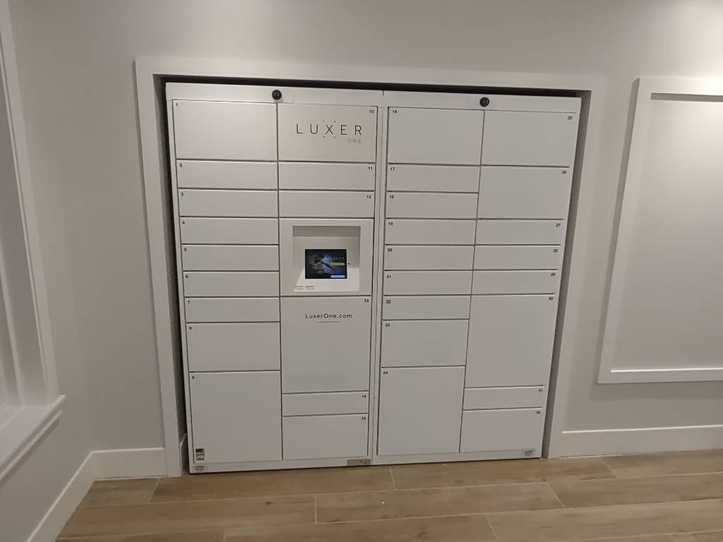 Luxer One indoor electronic package lockers installed in an apartment lobby