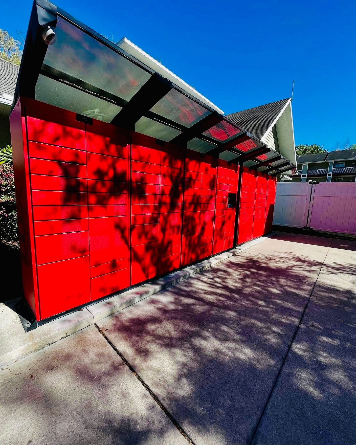 Red outdoor package lockers with weatherproof canopy