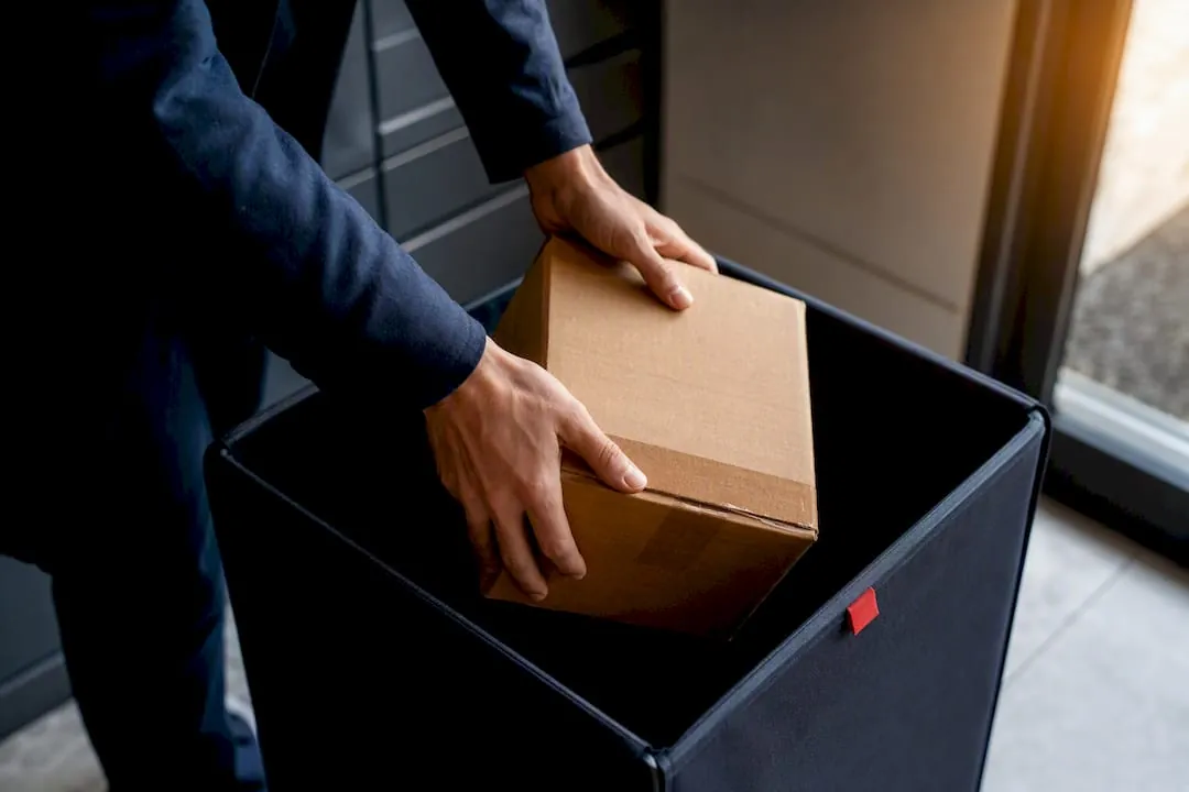 Property manager placing unclaimed parcel for return