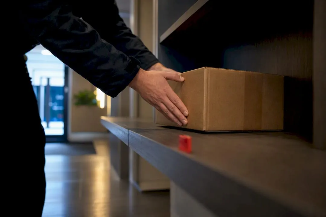 Carrier placing parcel on intake shelf
